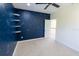 Bright bedroom features a constellation-themed accent wall, plush carpet, and a ceiling fan at 16637 Ashton Green Dr, Lutz, FL 33558