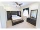 Well-furnished bedroom with a built-in headboard, dark wood dresser, and soft carpet flooring at 16637 Ashton Green Dr, Lutz, FL 33558