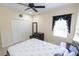 Bedroom with a large bed, dark wood furniture, and a window with elegant black curtains at 16637 Ashton Green Dr, Lutz, FL 33558