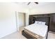 Spacious bedroom with modern built-in wardrobe, offering ample storage, and soft carpet flooring at 16637 Ashton Green Dr, Lutz, FL 33558