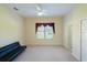 Cozy bedroom featuring neutral carpet, a ceiling fan, and a window with red curtains at 16637 Ashton Green Dr, Lutz, FL 33558