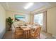 Inviting dining room featuring a wooden table with seating for six and beach-themed wall art at 16637 Ashton Green Dr, Lutz, FL 33558