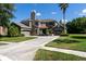 Well-maintained home with two-car garage, stone accents, and manicured lawn at 16637 Ashton Green Dr, Lutz, FL 33558