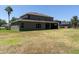 Back of a two-story house featuring a covered patio, large yard, and windows at 16637 Ashton Green Dr, Lutz, FL 33558
