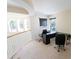 Bright home office featuring large windows, neutral paint, and a simple desk setup at 16637 Ashton Green Dr, Lutz, FL 33558