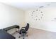 Home office with a large wall clock, neutral paint, and a simple desk setup at 16637 Ashton Green Dr, Lutz, FL 33558