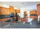 Well-lit kitchen boasting wooden cabinets, stainless steel appliances, and a granite countertop at 16637 Ashton Green Dr, Lutz, FL 33558