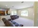 Open-concept living room features comfortable leather sofas and a sunny window at 16637 Ashton Green Dr, Lutz, FL 33558