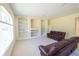 Large living room features built-in shelves, recessed lighting, and comfortable brown leather sofas at 16637 Ashton Green Dr, Lutz, FL 33558