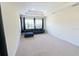 Spacious living room with a tray ceiling, plush blue sofa and large windows at 16637 Ashton Green Dr, Lutz, FL 33558