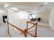 Loft area with curved railings overlooking the first floor, windows, and an office area at 16637 Ashton Green Dr, Lutz, FL 33558
