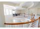 Spacious loft area with curved railings, an office space, and an open view of the first floor at 16637 Ashton Green Dr, Lutz, FL 33558