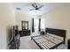 Bedroom with a ceiling fan and empty bedframe, with views of the backyard from the windows at 16637 Ashton Green Dr, Lutz, FL 33558