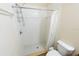 Shower featuring white tile, shower head, and shower curtain at 16637 Ashton Green Dr, Lutz, FL 33558