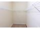 Empty walk-in closet featuring carpet flooring and white wire shelving offering ample storage space at 16637 Ashton Green Dr, Lutz, FL 33558
