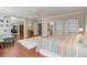 Spacious primary bedroom featuring hardwood floors, ensuite bath and walk-in closet at 1750 Arabian Ln, Palm Harbor, FL 34685