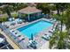 Relaxing community pool area with ample seating, lounge chairs and a covered patio, perfect for enjoying sunny days at 1750 Arabian Ln, Palm Harbor, FL 34685