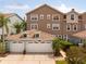 Inviting exterior view of a multi-story townhouse with a two-car garage and tile roof at 1750 Arabian Ln, Palm Harbor, FL 34685