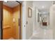 Well-lit hallway featuring a residential elevator, tile flooring, and neutral wall colors at 1750 Arabian Ln, Palm Harbor, FL 34685
