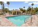 Community pool with ample lounge seating and covered pavilion at 1750 Arabian Ln, Palm Harbor, FL 34685