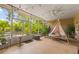 Relaxing sun room with string lights, plants, and view of the backyard at 1750 Arabian Ln, Palm Harbor, FL 34685