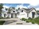 Stunning single-Gathering home with modern farmhouse design, manicured landscaping, and a paved driveway at 19453 Sheltered Hill Dr, Brooksville, FL 34601