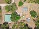 Aerial view of estate property with house, barns and lush surrounding landscape at 19708 Bower Rd, Dade City, FL 33523
