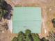 Aerial shot of barn with green roof surrounded by trees and open space at 19708 Bower Rd, Dade City, FL 33523