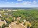 Scenic aerial view of the estate with lakes, houses, barns, and expansive forests at 19708 Bower Rd, Dade City, FL 33523