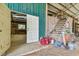 View of barn interior with storage, shelving, and stairs leading to a loft area at 19708 Bower Rd, Dade City, FL 33523
