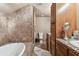A full bathroom with tile surround, shower and soaking tub at 19708 Bower Rd, Dade City, FL 33523