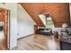 Bedroom featuring wood ceiling, wood flooring, a futon, and natural light at 19708 Bower Rd, Dade City, FL 33523