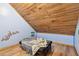 Cozy bedroom with wood floors, natural wood ceiling, and a blue accent wall at 19708 Bower Rd, Dade City, FL 33523