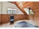 Bonus room with wood paneled wall, vaulted ceilings, and natural light at 19708 Bower Rd, Dade City, FL 33523