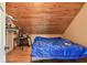 Attic bedroom with sloped ceilings and a covered bed at 19708 Bower Rd, Dade City, FL 33523