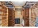 Walk-in closet with wooden shelving and organization system, providing ample storage space at 19708 Bower Rd, Dade City, FL 33523