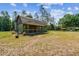 Exterior view of a charming single-story home with a covered porch and grassy yard at 19708 Bower Rd, Dade City, FL 33523