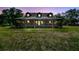 Charming log cabin with a spacious porch, nestled among mature trees, creating a serene and inviting ambiance at 19708 Bower Rd, Dade City, FL 33523