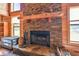 A stone fireplace with a wooden mantle, perfect for gathering and creating a cozy atmosphere at 19708 Bower Rd, Dade City, FL 33523