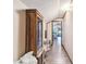 Hallway with wood floors and built in cabinet with access to the living room at 19708 Bower Rd, Dade City, FL 33523