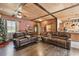 Comfortable living room with wood ceiling, laminate wood flooring, and comfortable brown leather furniture at 19708 Bower Rd, Dade City, FL 33523