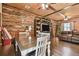 Rustic dining room area with wood accent wall, table and chairs, built-in shelving and wood floors at 19708 Bower Rd, Dade City, FL 33523