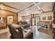 Open-concept living room with wood ceiling, comfortable leather furniture, and view into the kitchen at 19708 Bower Rd, Dade City, FL 33523