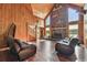 Cozy living room featuring a stone fireplace, hardwood floors, and high ceilings, creating a warm and inviting atmosphere at 19708 Bower Rd, Dade City, FL 33523