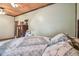 Main bedroom with wood ceiling, laminate wood flooring, and view of wood dresser at 19708 Bower Rd, Dade City, FL 33523