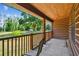 Exterior shot of a covered porch with a chair and a view of the yard at 19708 Bower Rd, Dade City, FL 33523