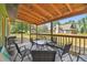 View of the covered porch featuring a table, chairs, and a view of another home at 19708 Bower Rd, Dade City, FL 33523