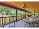Relaxing porch with a ceiling fan, rocking chairs, and a view of the lush greenery at 19708 Bower Rd, Dade City, FL 33523