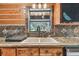 Well-lit kitchen sink area with granite countertops, tile backsplash, and a window offering scenic views of the outdoors at 19708 Bower Rd, Dade City, FL 33523