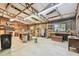 Large workshop space with ample lighting, workbenches, and shelving for tools and projects at 19708 Bower Rd, Dade City, FL 33523